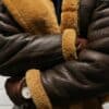 a close up of a person wearing a brown jacket