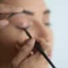 person holding black pen in close up photography