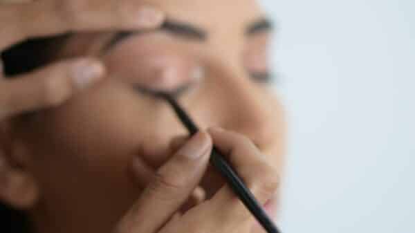 person holding black pen in close up photography