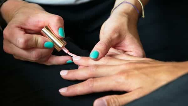 a person's hands with painted nails