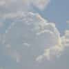 A plane flying in the sky with a lot of clouds