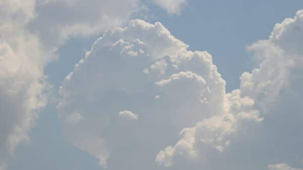 A plane flying in the sky with a lot of clouds