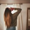 woman in gray long sleeve shirt and blue denim jeans