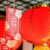 a couple of red lanterns hanging from a ceiling