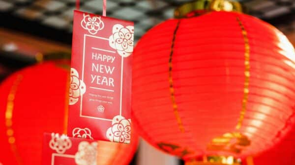 a couple of red lanterns hanging from a ceiling