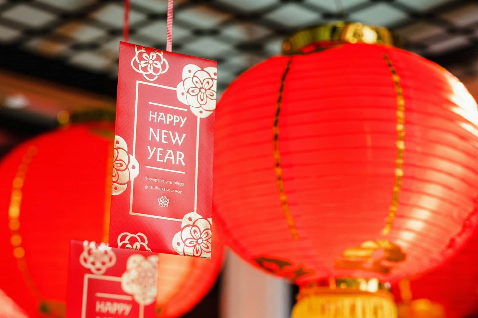 a couple of red lanterns hanging from a ceiling