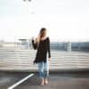 woman standing on gray concrete pavement