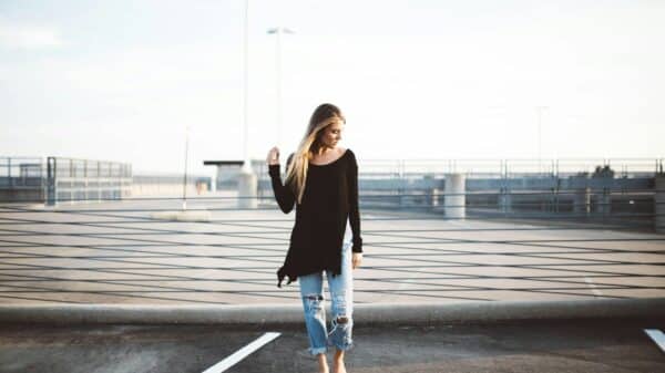 woman standing on gray concrete pavement