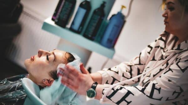 a man getting his hair washed in a salon