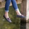 a woman's feet hanging off the edge of a dock