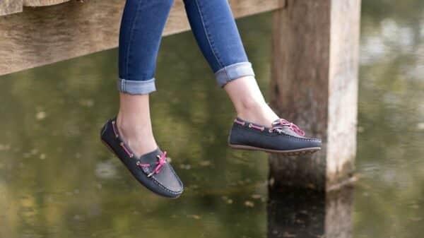 a woman's feet hanging off the edge of a dock