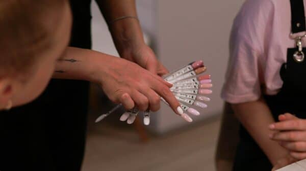 a woman holding a bunch of nails in her hands