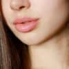 a close up of a woman with long brown hair