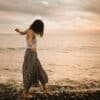 woman walking on rocks in beach