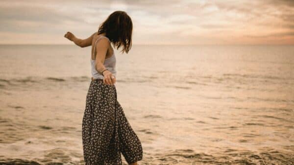 woman walking on rocks in beach