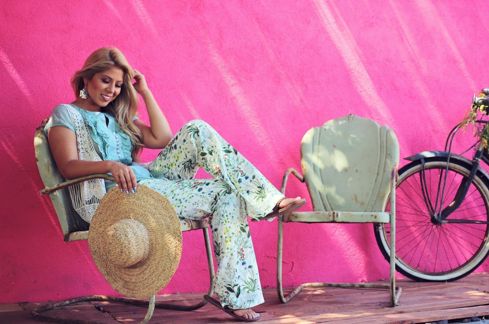 a woman sitting on a chair next to a bike