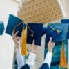 a group of people holding blue and yellow hats