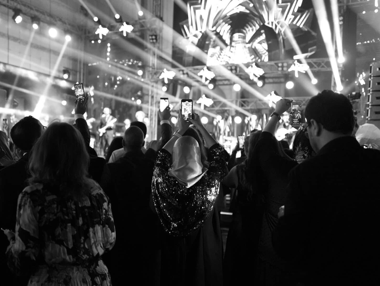 a crowd of people standing around a stage