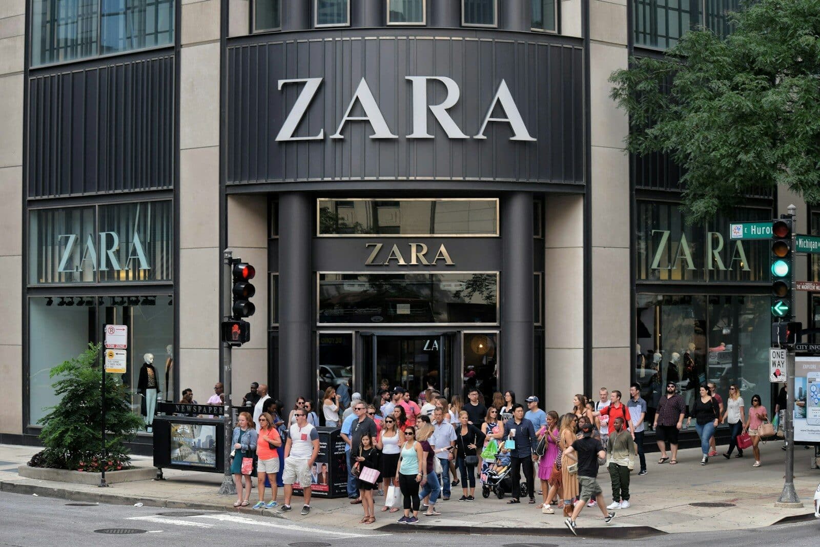a group of people walking on the sidewalk