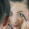 a woman is looking at her reflection in the mirror