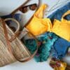 blue denim jeans beside yellow leather handbag