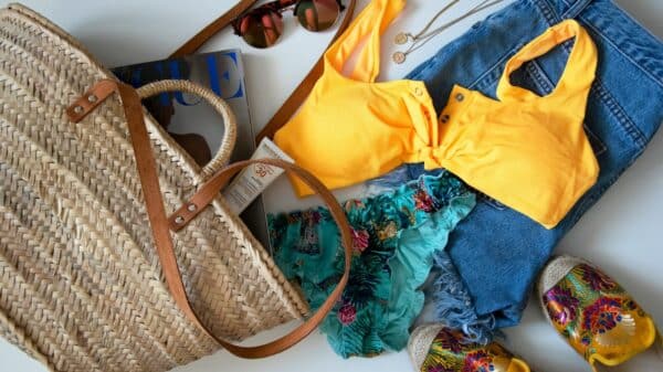 blue denim jeans beside yellow leather handbag