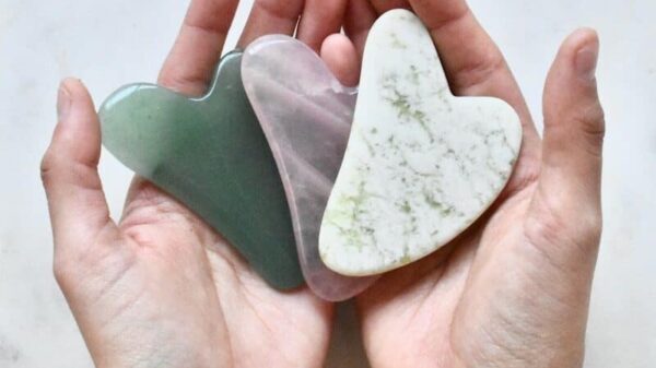two hands holding two heart shaped pieces of soap