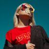 woman with sunglasses standing outdoor during daytime