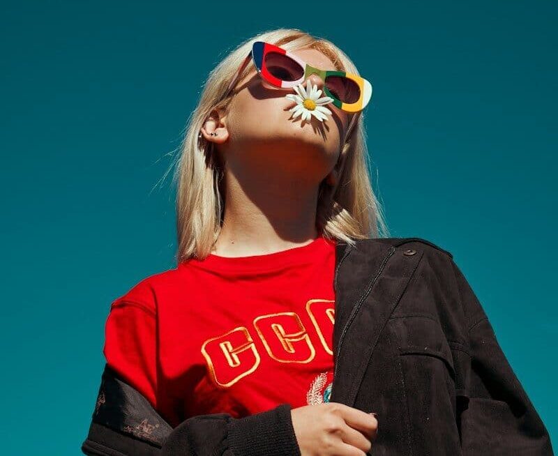 woman with sunglasses standing outdoor during daytime