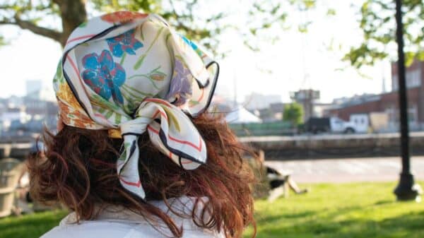 a woman in a park with a bandana on her head
