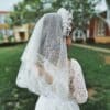 a woman in a white wedding dress and veil