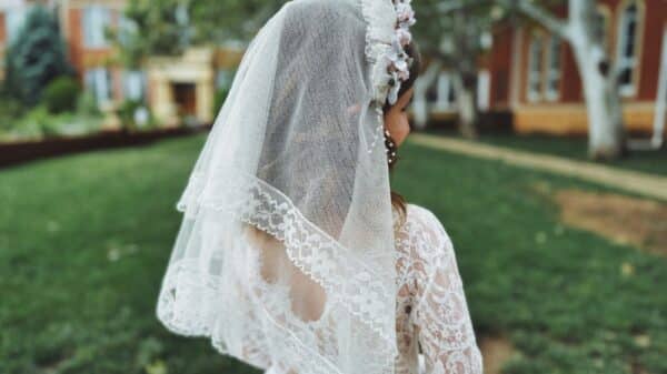 a woman in a white wedding dress and veil