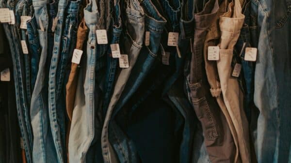 A rack of jeans hanging on a wall
