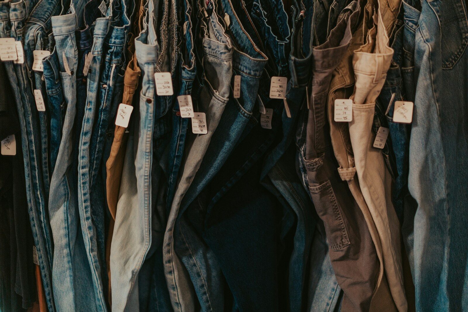 A rack of jeans hanging on a wall